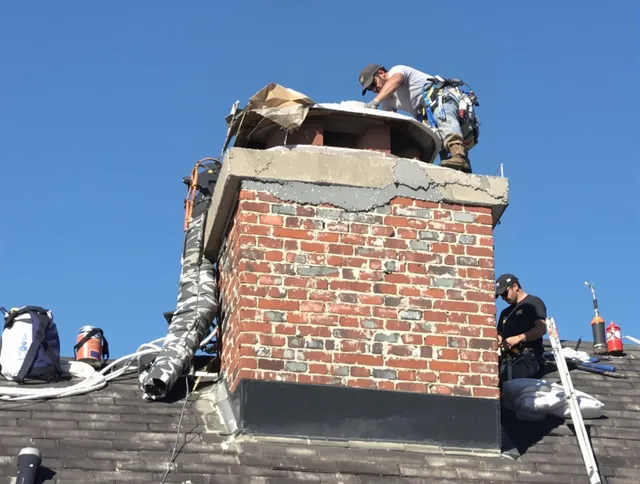 Northbridge Chimney Sweep installing a custom chimney crown in Northbridge, MA