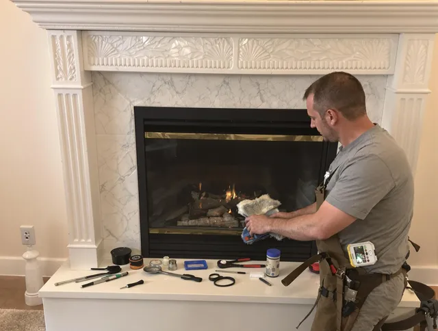 Northbridge Chimney Sweep performing fireplace maintenance in Northbridge, MA